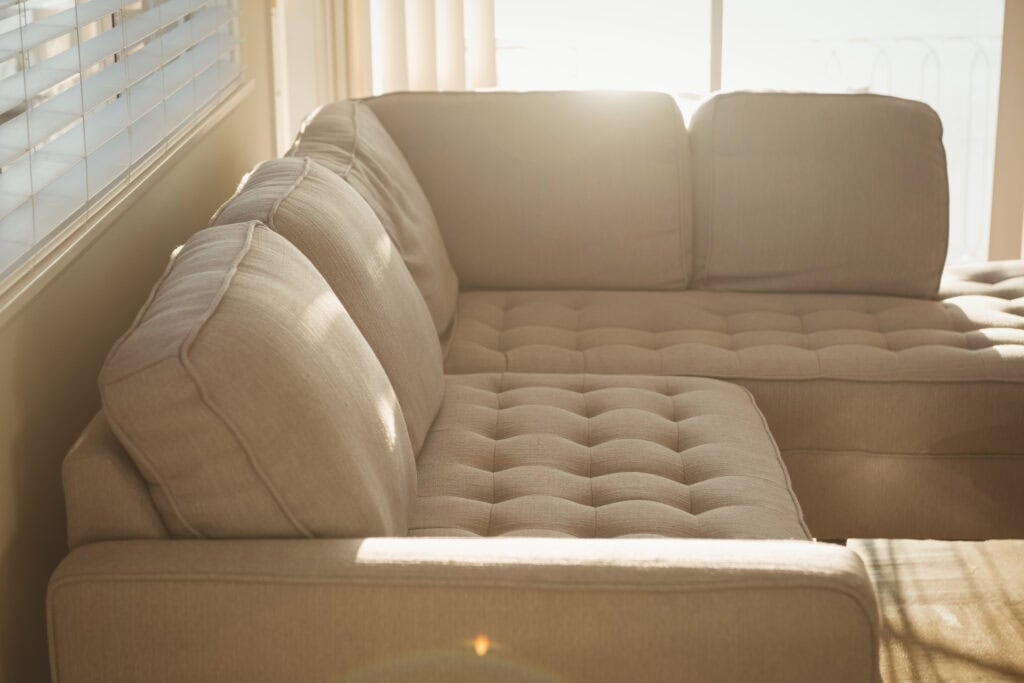 Close-up of a cream-colored tufted sofa