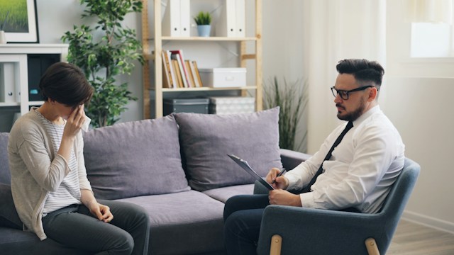 young adult having a calm conversation with a psychiatrist schizoaffective vs bipolar